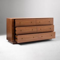 a wooden dresser sitting on top of a white floor