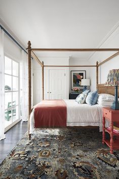 a bedroom with a four poster bed and colorful furniture