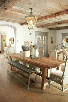 a dining room table with chairs and a bench