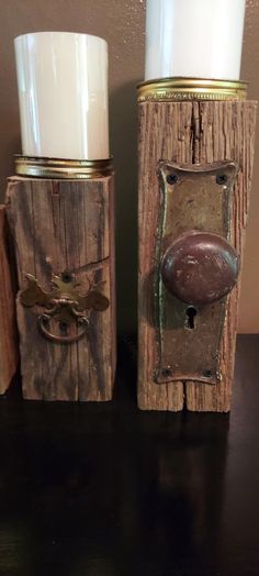 two candle holders made out of wood and metal