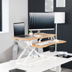 a computer desk with a laptop on it