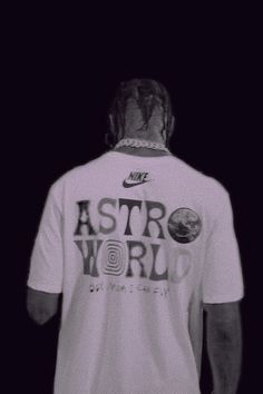 a man with his back turned to the camera wearing a white shirt that says astro world