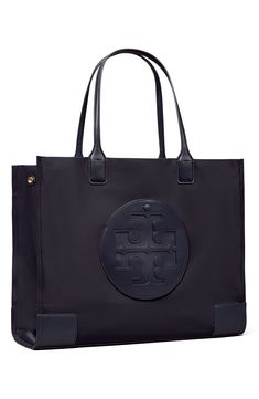 A classic tote made from durable nylon with a stacked-T logo in faux leather is that perfect accessory for your on-the-go style. 17.3”W x 13.2”H x 5.2”D   Structured silhouette with flat base for stability   Recycled polyester lining   Recycled nylon   Imported Classic Nylon Shopping Bags, Navy Tote Bag With Detachable Handle, تلوث المياه, Tory Burch Quadrant Tote, Tory Burch Robinson Convertible Bag, Tory Burch Perry Tote, Tory Burch Ella Tote, Tory Burch Navy Blue Bag, Ella Tote