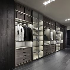 a large walk in closet with lots of drawers