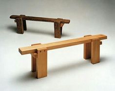 two wooden benches sitting next to each other on top of a white floor covered ground