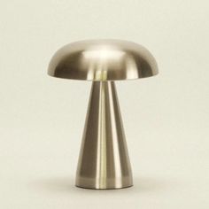 a shiny metal object on a white background