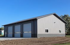 two garages in the middle of a dirt lot