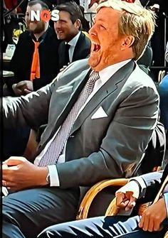 a man sitting in a chair with his mouth open