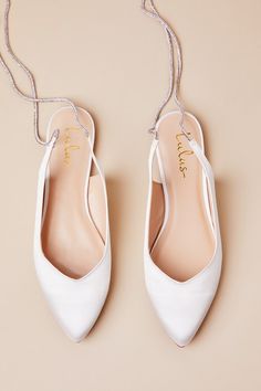 You can strut down the aisle or dance the night away in effortless style and comfort, thanks to the Lulus Finnian White Satin Rhinestone Lace-Up Pointed-Toe Flats! Luxe woven satin shapes these diva-approved flats that feature a classic pointed-toe upper and a low-cut collar that continues into long, rhinestone-embellished laces that wrap and tie above the ankle. 0. 25" rubber heel. Lightly cushioned insole. Felted rubber sole has nonskid markings. Man made materials. Imported. Lulus | Finnian W Wedding Shoes Bride Flats, Bride Flats, Sparkly Flats, Shoes Bride, Sparkly Shoes, Wedding Shoes Bride, Sparkly Wedding, Pointed Toe Flats, Fall Shoes