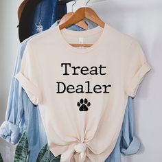 Treat Dealer Shirt, Pet Shirt, Dog Mom Shirt, Dog Shirt for Pet Owner, Dog Treat Shirt Available in all styles and colors - please message us! If you have any questions about materials, shipping times, sizes or just want to chat, please feel free to message us. Care- Machine wash in cold water, inside out, and tumble dry. Shipping: Please allow 1-5 business days for the item to be made and shipped out! Could be soon we will keep you posted! What we offer: - High Quality Soft T-shirts - Safe Paym Dog Birthday Shirts, Shirts For Dog Lovers, Pet Shirts For People, Dog Merchandise Ideas, Dog Mom Apparel, Dog Shirts For People, Dog Tshirt Ideas, Funny Dog Sayings, T Shirt Ideas