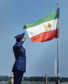 a woman in uniform saluting at the flag