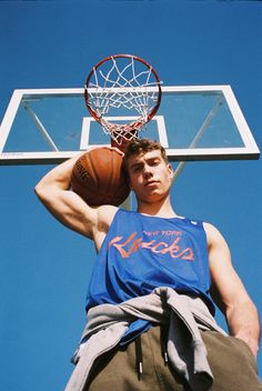 a man standing in front of a basketball hoop