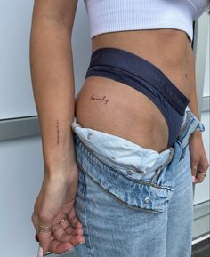 a close up of a person's stomach with the word love tattooed on it