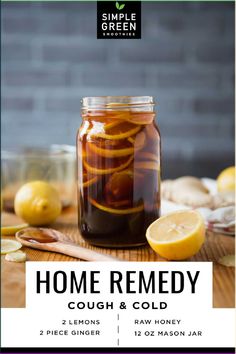 a jar filled with liquid sitting on top of a table next to sliced lemons