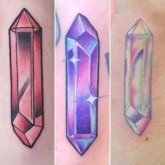 three different colored tattoos on the side of their bodies, each with an image of a crystal