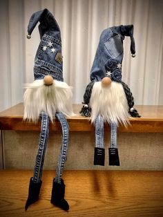 two gnomes made out of jeans are sitting on a shelf next to each other