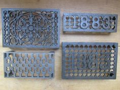 four cast iron grates on a wooden table