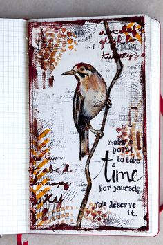 an open journal with a bird sitting on a tree branch