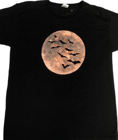 Bats flying in front of the moon painted on a black t-shirt using bleach. Painted on the Fruit of the loom Original T.  Their T-shirts run slightly smaller so pick a size bigger than you would normally go for when buying from other brands. The sizes are S 35/37", M 38/40", L 41/43", XL 44/46", 2XL 47/49", 3XL 50/52" (measured all the way around the widest part of your chest in inches). I've also included their product specifications in the photos (measured in cm across the front of the shirt whe Spiderweb Bleach Shirt, Spider Bleach Shirt, Black Bleached Halloween Shirt Diy, Bleached Shirt Designs, Bat Bleach Shirt, Bleach Painting Clothes Goth, Bleach Art Shirts, Bleach Painting Clothes, Bleached Clothing