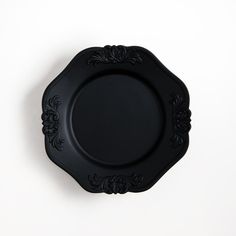 an empty black plate on a white background