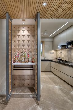 an open door leading to a kitchen filled with lots of counter top space and cabinets