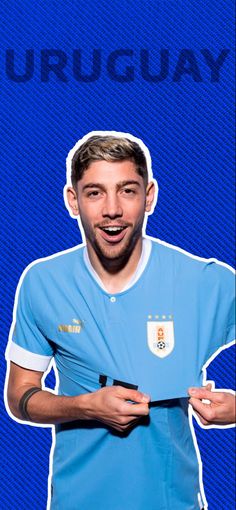 a man holding a soccer ball in front of his face with the word uruguay on it