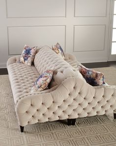 a couch sitting on top of a carpeted floor next to a white closet door