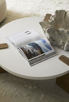 a white table with a magazine on it