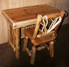 a wooden table with two chairs next to it