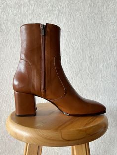 Handmade Tan Leather Boots for Women | Stylish Women's Tan Boots | Custom Tan Leather Booties | Trendy Women's Footwear Key Features: * Handmade Quality: Each pair is carefully handcrafted. *  Tan Leather: Features a vibrant tan  leather finish for a glossy, eye-catching look. * Versatile Design: Suitable for a variety of occasions, from casual outings to elegant events. * Durable Construction: Made with high-quality materials for long-lasting wear and durability. Ideal for: *  Everyday Wear: Pair with jeans or leggings for a chic, standout look. * Perfect for Dresses and Skirts: Perfect for adding a sophisticated touch to your favorite dresses and skirts. SIZE GUIDE Fables Mary Jane shoes are true to size. However, if you have a high instep or a wide foot, we would recommend sizing up. Al Carmina Boots Women, Camal Boots, Cognac Womens Boots, Womens Tan Leather Boots, Tan Womens Boots, Chameau Boots, Leather Boots For Women, Camel Boots, Tan Leather Boots