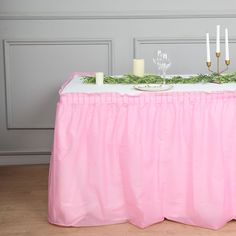 the table is set with candles and greenery