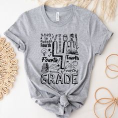 a t - shirt with the words fourth grade written in different languages on it next to some other items