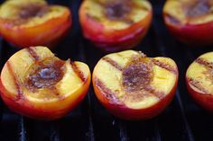 three peaches are being grilled on the grill