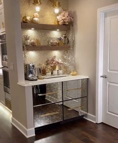 a kitchen area with an oven and shelves on the wall