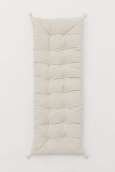 a white sleeping bag hanging on the wall