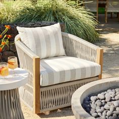 a chair sitting on top of a patio next to a table with drinks in it