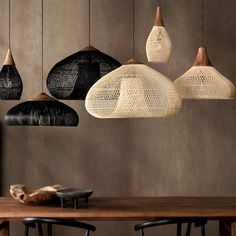 a wooden table topped with lots of black and white lights hanging from it's ceiling