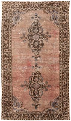 an antique persian rug with brown and beige colors