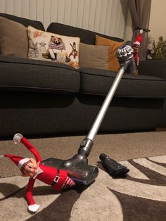 an elf vacuum cleaning the floor in front of a couch