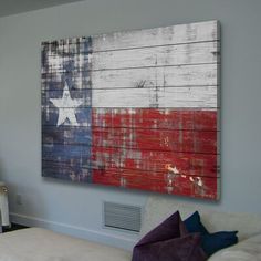 an american flag painted on the side of a wall next to a bed and chair