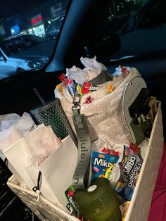 a car trunk filled with lots of food and snacks in it's back seat