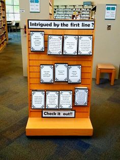 a display in the middle of a library filled with lots of books and information cards