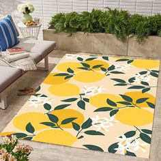 a yellow area rug with lemons and leaves on it