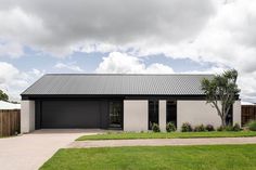 a white house with a black garage door