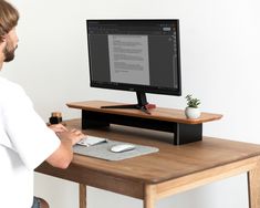 a man standing in front of a computer monitor