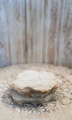 three pieces of food are stacked on top of each other in front of a wooden wall