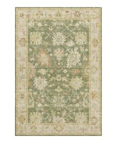 an area rug with green and beige colors