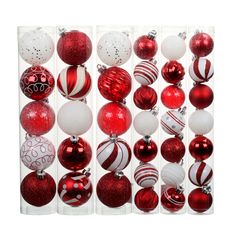 red and white christmas ornaments in a clear display case on a white background with space for text