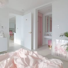 a bedroom with white walls and pink bedding