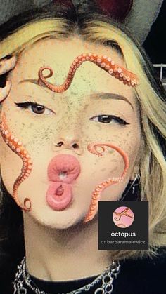 a woman with her tongue out and an octopus painted on her face is making a funny face